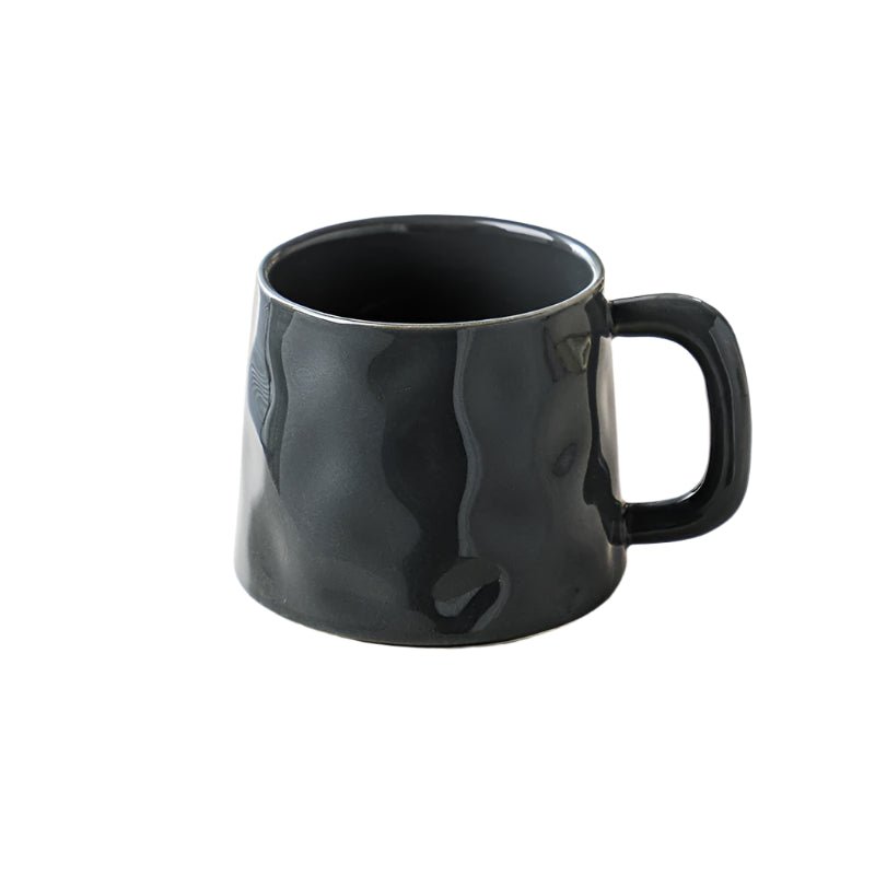 Black ceramic mug with a textured surface on a white background
