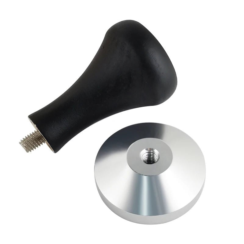 Black handle with metal disc on a white background