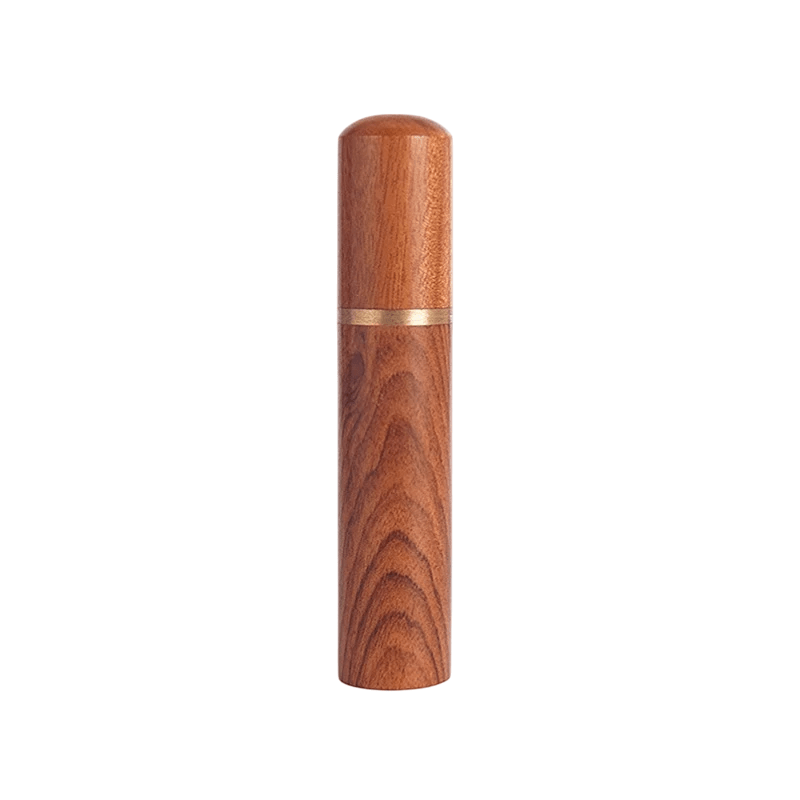 Wooden cylindrical object with a gold accent on a white background