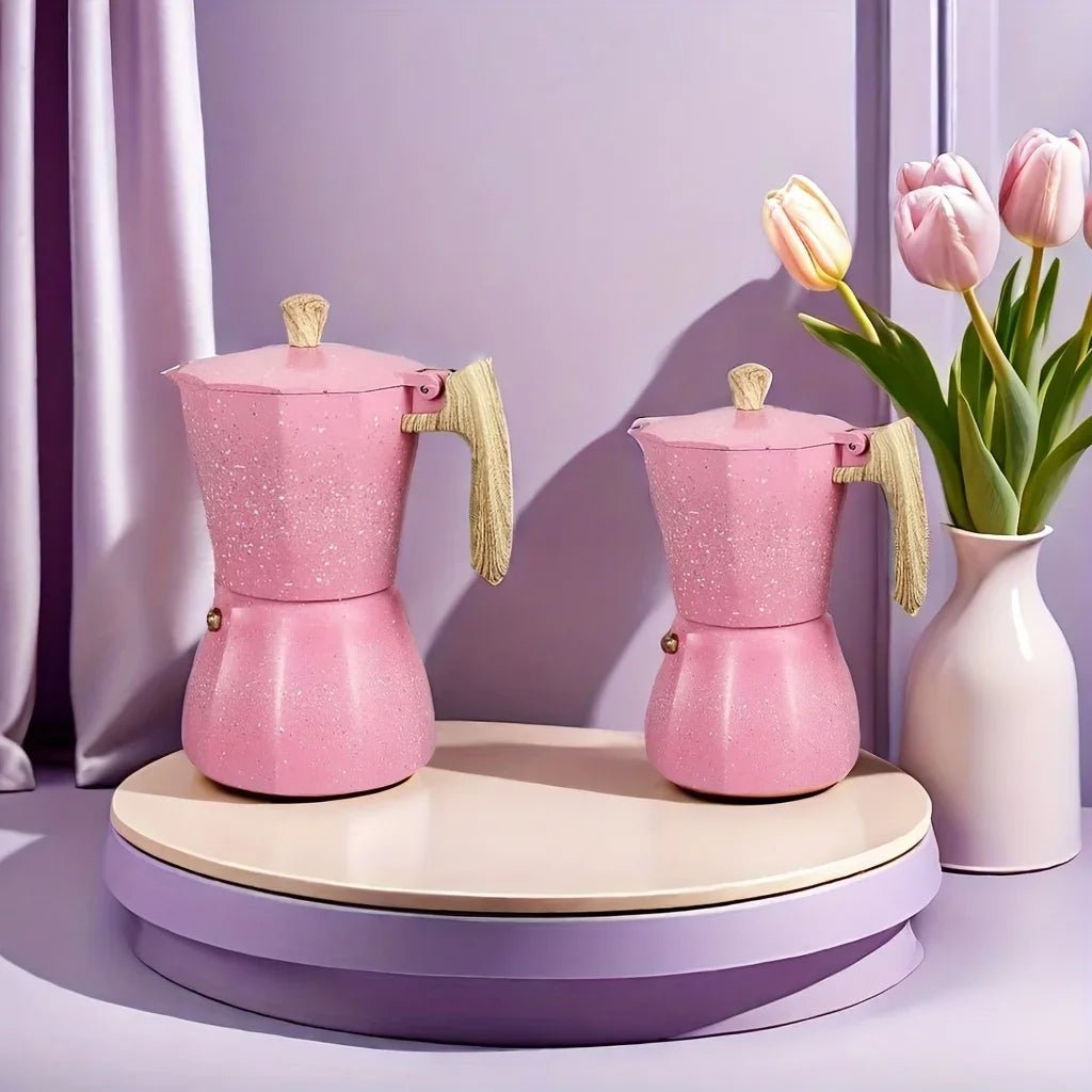 Two pink coffee makers on a wooden stand with a vase of tulips in the background.
