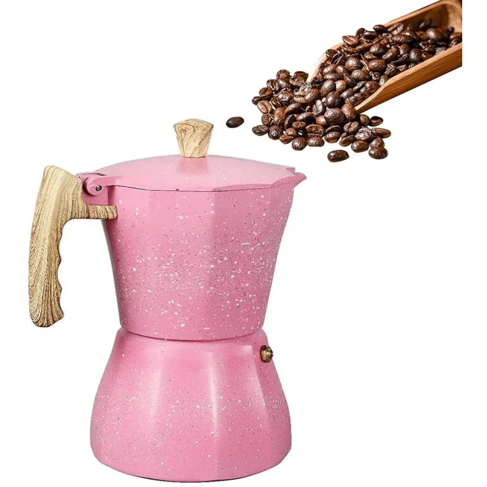 Pink stovetop espresso maker with wooden handle and coffee beans on a white background
