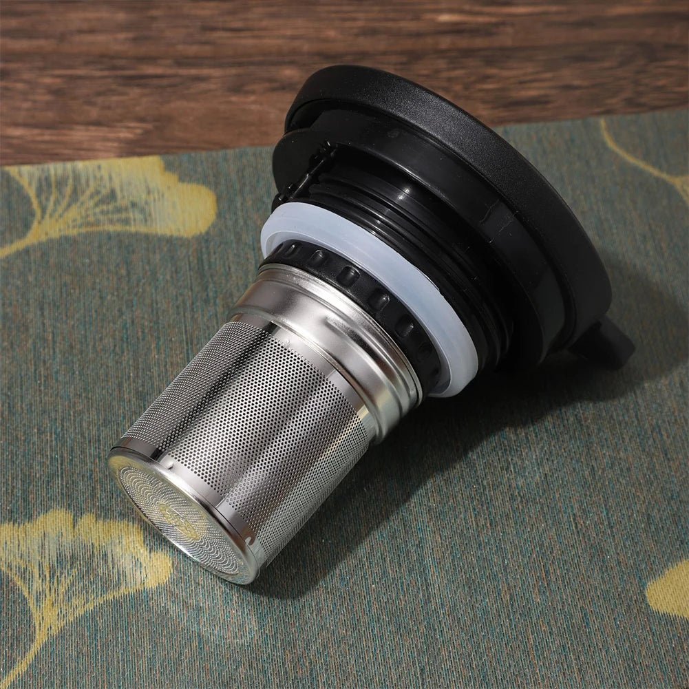 Metal coffee filter on a textured surface with a wooden background
