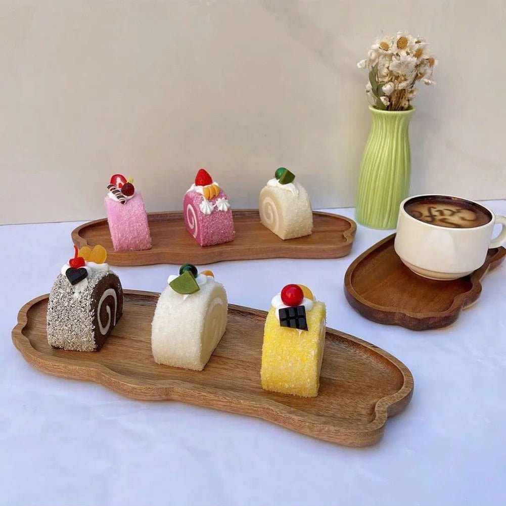 cakes on wooden trays with a cup of coffee and a vase in the background.