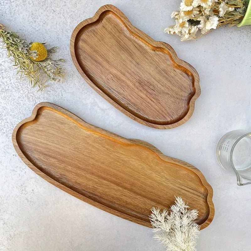 Two wooden trays on a light surface with dried flowers.