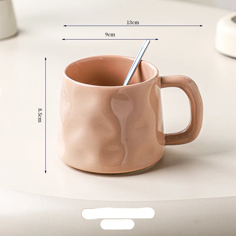 Pink ceramic mug with dimensions marked on a light background