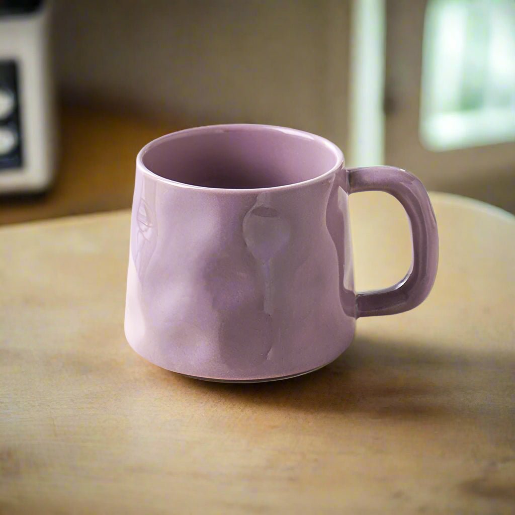 Purple mug with a marble pattern on a wooden surface
