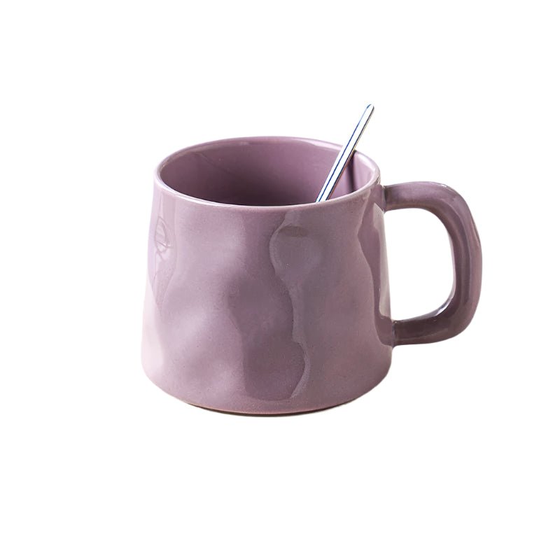 Purple mug with a spoon on a white background