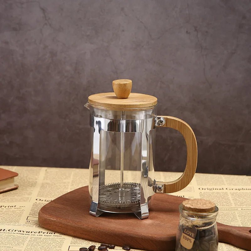 French press coffee maker with wooden lid and handle on a rustic background