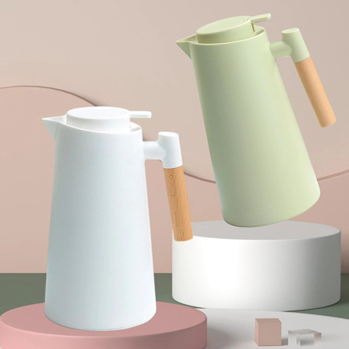 Two Thermal Coffee Carafe, one white and one green, with wooden handles on a pink and gray background.