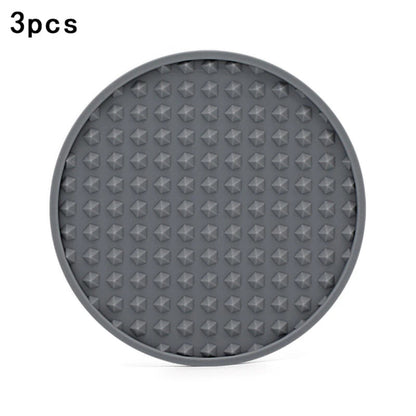 grey silicone coaster with different patterns on a white background