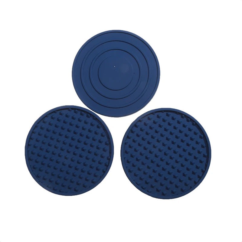 Three blue silicone coasters on a white background