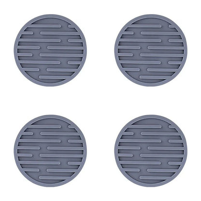 Four grey silicone coasters with textured surface on a white background