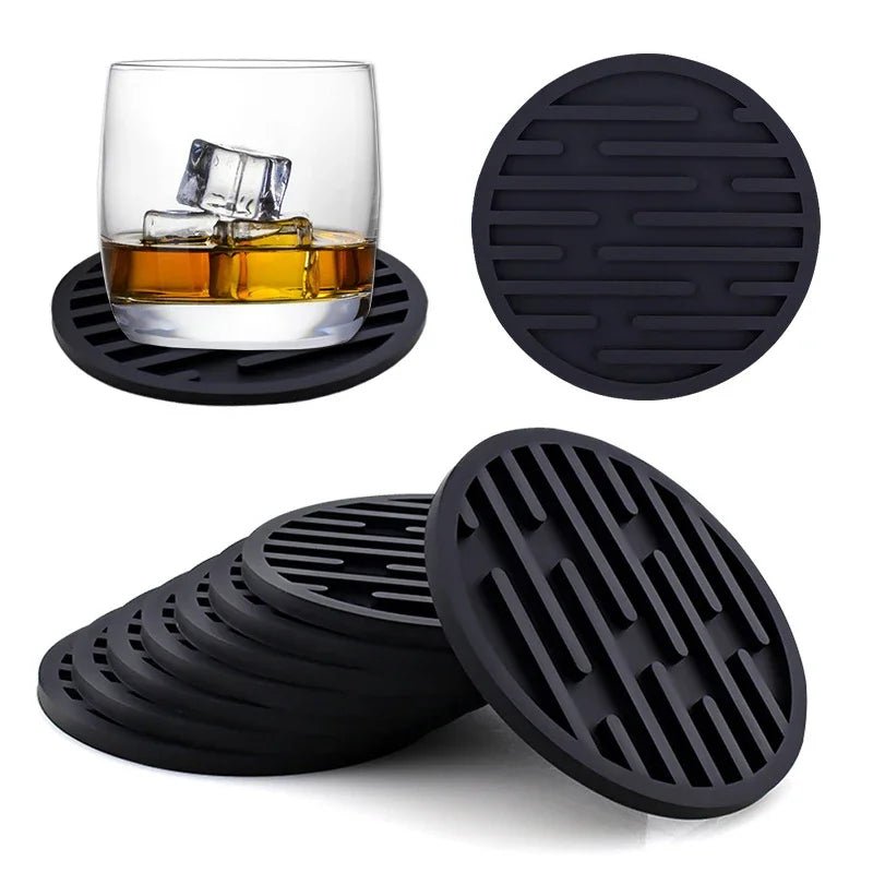 Black silicone coasters with a glass on a white background