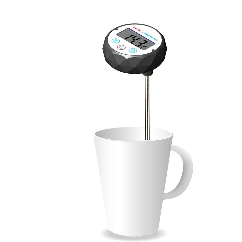 Digital thermometer inserted into a white mug on a white background