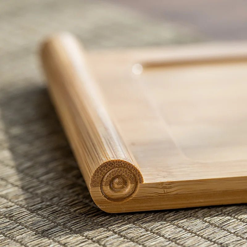 Close-up of a wooden tray with a decorative corner on a textured surface