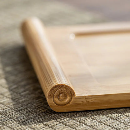 Close-up of a wooden tray with a decorative corner on a textured surface