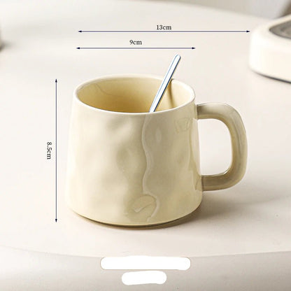 Beige ceramic mug with dimensions labeled on a white background