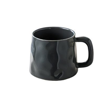 Black ceramic mug with a textured surface on a white background