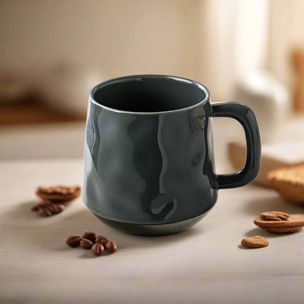 Black mug on a table with coffee beans and pecans