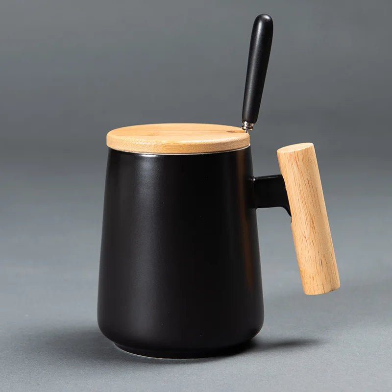 Black mug with wooden lid and handle on a gray background