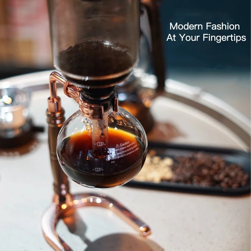 Siphon coffee apparatus with coffee brewing, surrounded by coffee beans on a blurred background.