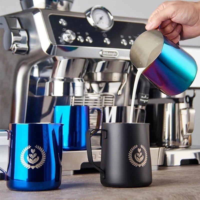 Espresso machine with blue and black mugs and a person pouring coffee.