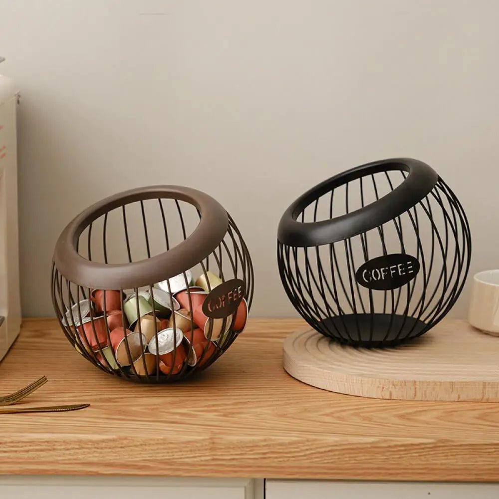 Two wire coffee bean containers on a wooden surface with a neutral background
