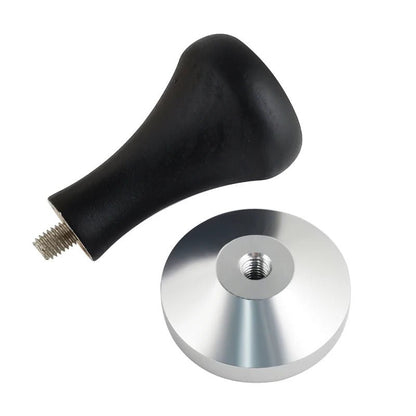 Black handle with metal disc on a white background