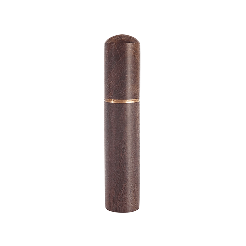 Wooden cylindrical object with a gold accent on a white background