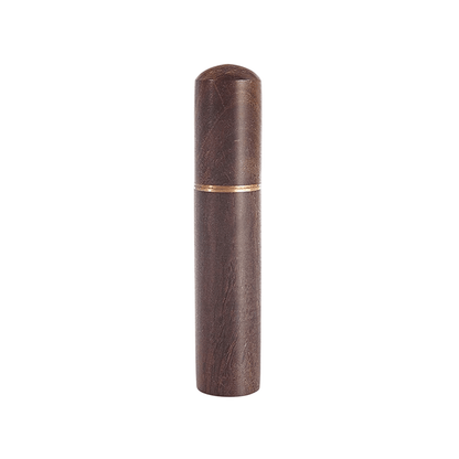 Wooden cylindrical object with a gold accent on a white background