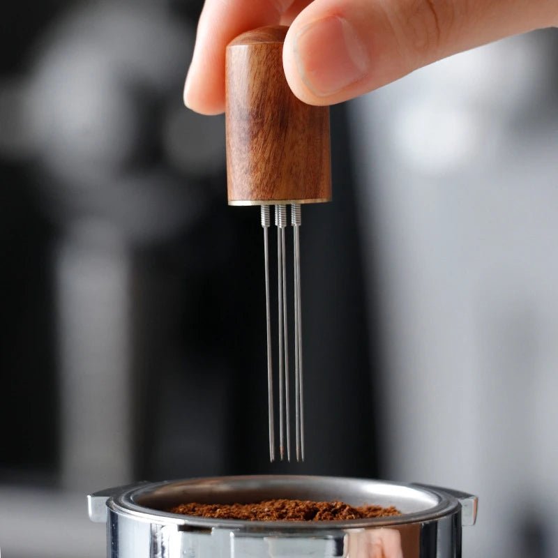 Wooden coffee tamping tool being used on a portafilter with blurred background