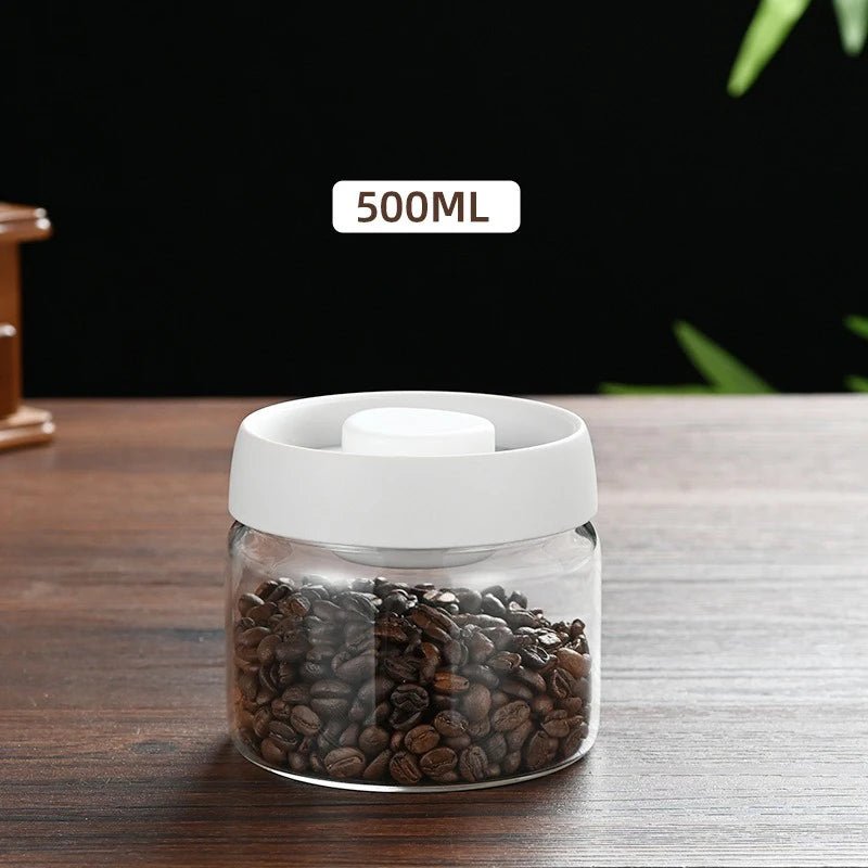 Clear container with white lid filled with coffee beans on a wooden surface