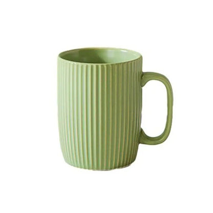 Green mug with ribbed texture on a white background