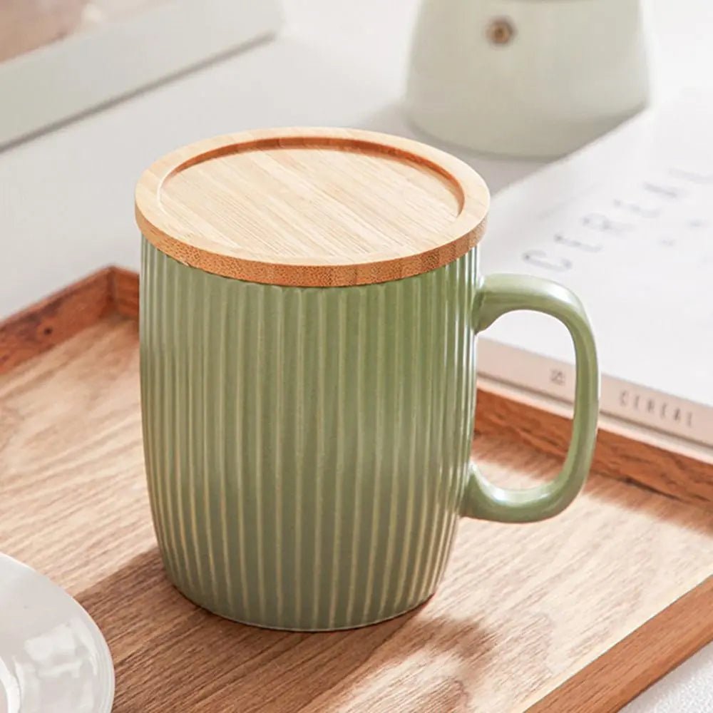 Green mug with wooden lid on a wooden tray