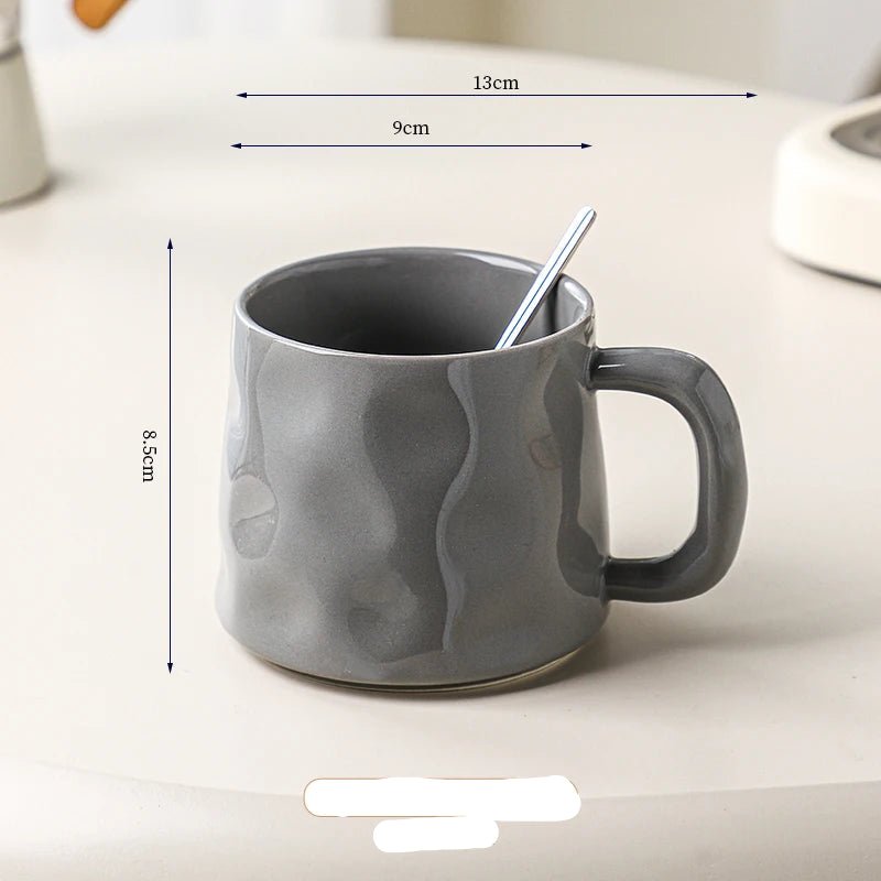 Gray ceramic mug with dimensions labeled on a light background