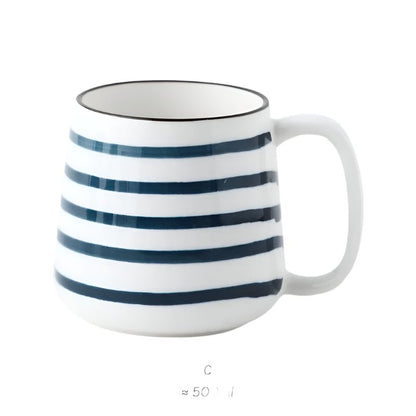 White mug with blue stripes on a white background
