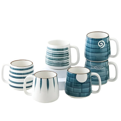 Set of ceramic mugs with blue and white patterns on a white background