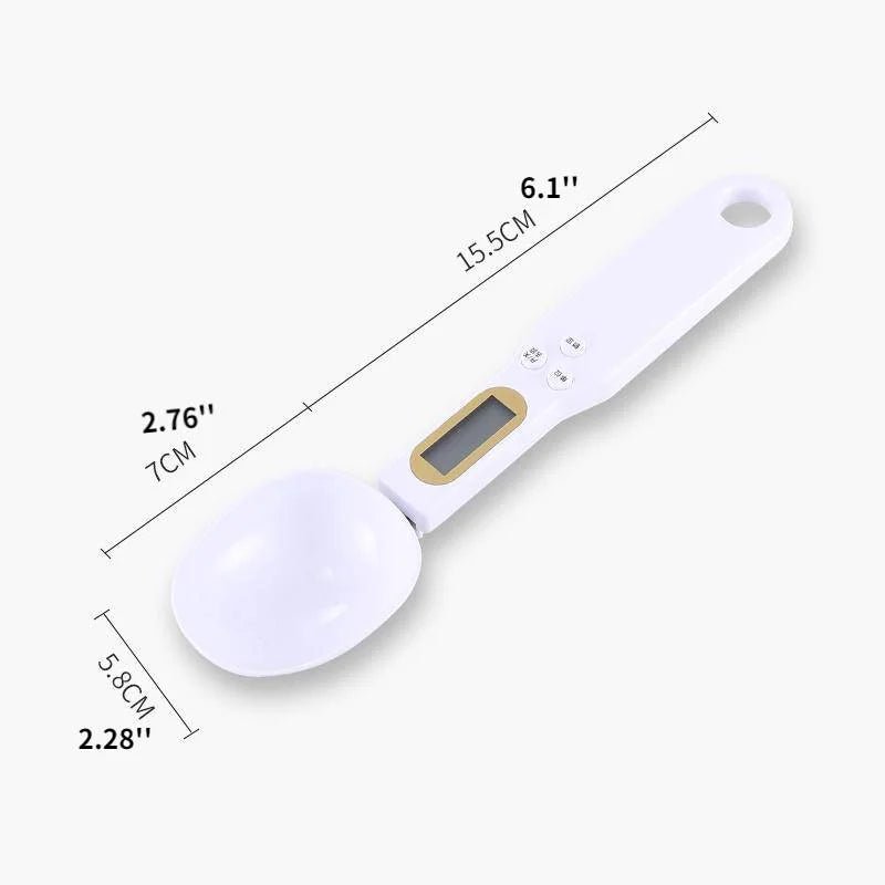 White digital measuring spoon with gold accents and measurements labeled on a white background