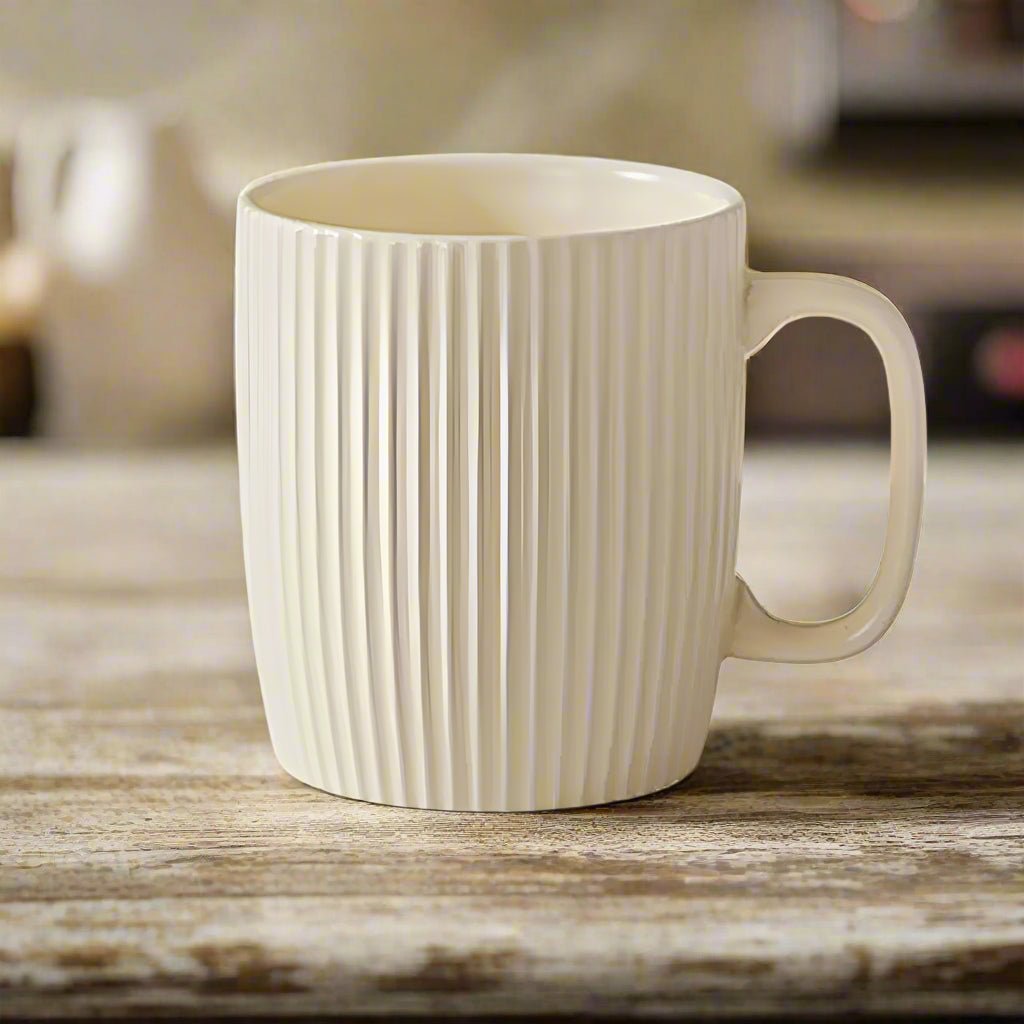 White ceramic mug with ribbed texture on a wooden surface