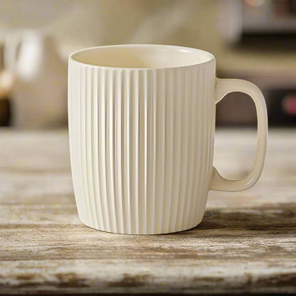 White ceramic mug with ribbed texture on a wooden surface