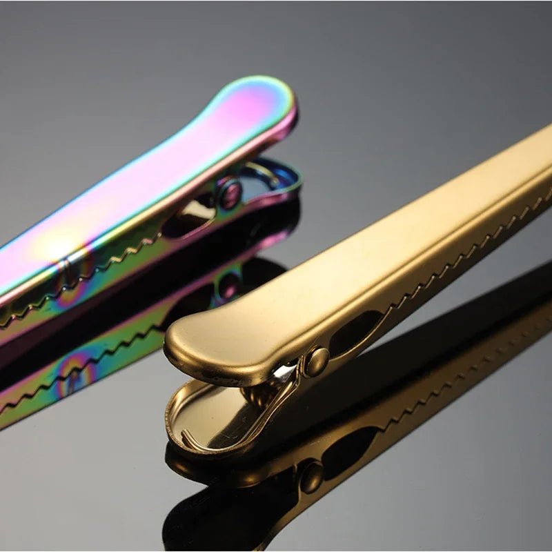 Close-up of a gold pocket knife with a reflective surface on a gray background