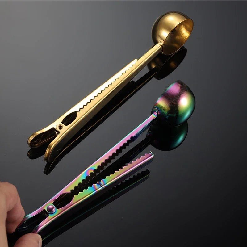 Gold and multicolored tongs on a reflective black surface