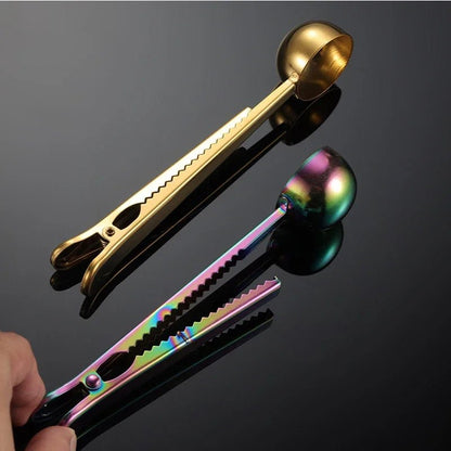 Gold and multicolored tongs on a reflective black surface