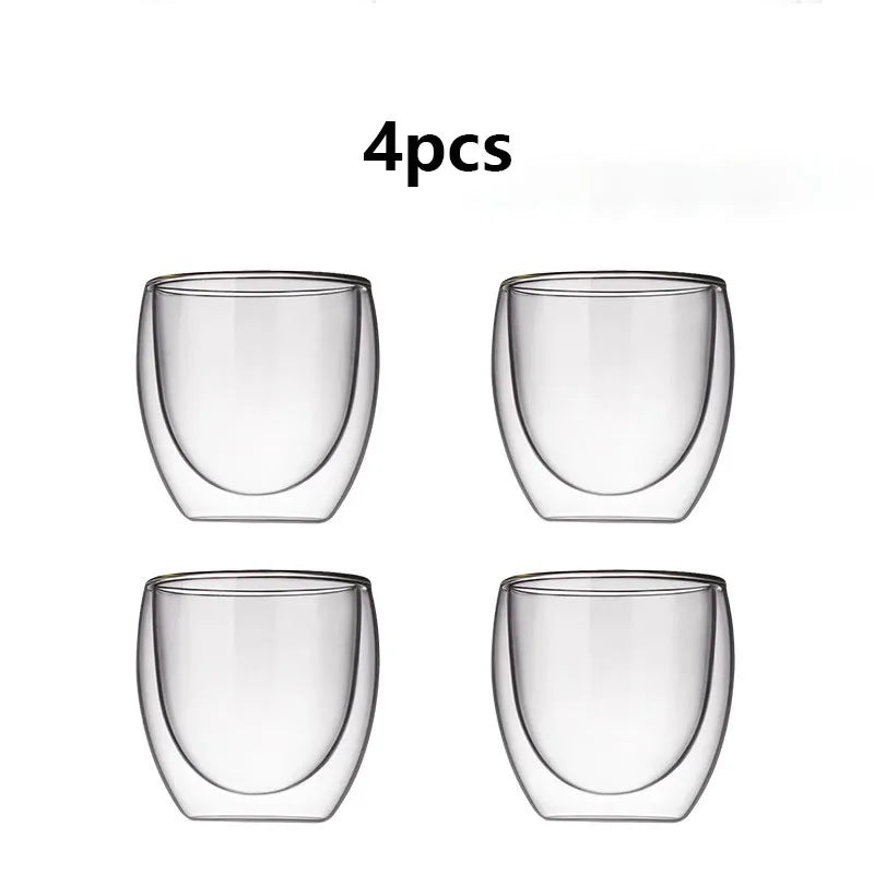 Four clear glass tumblers on a white background