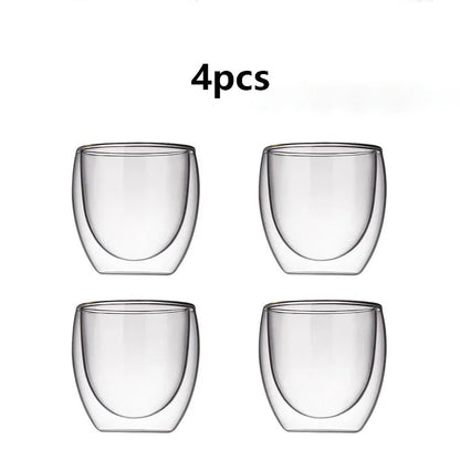 Four clear glass tumblers on a white background