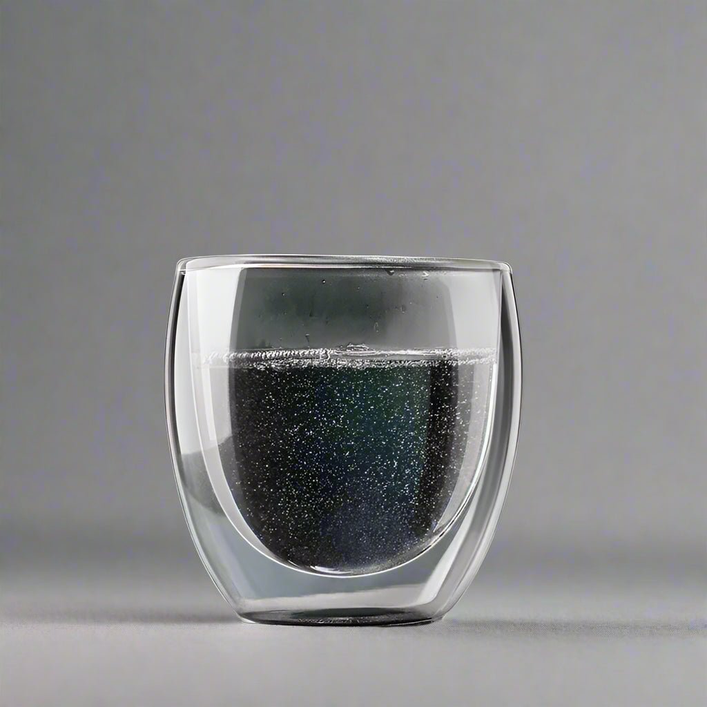 Double-walled glass with black interior on a gray background