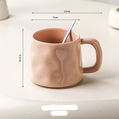 Pink ceramic mug with dimensions marked on a light background