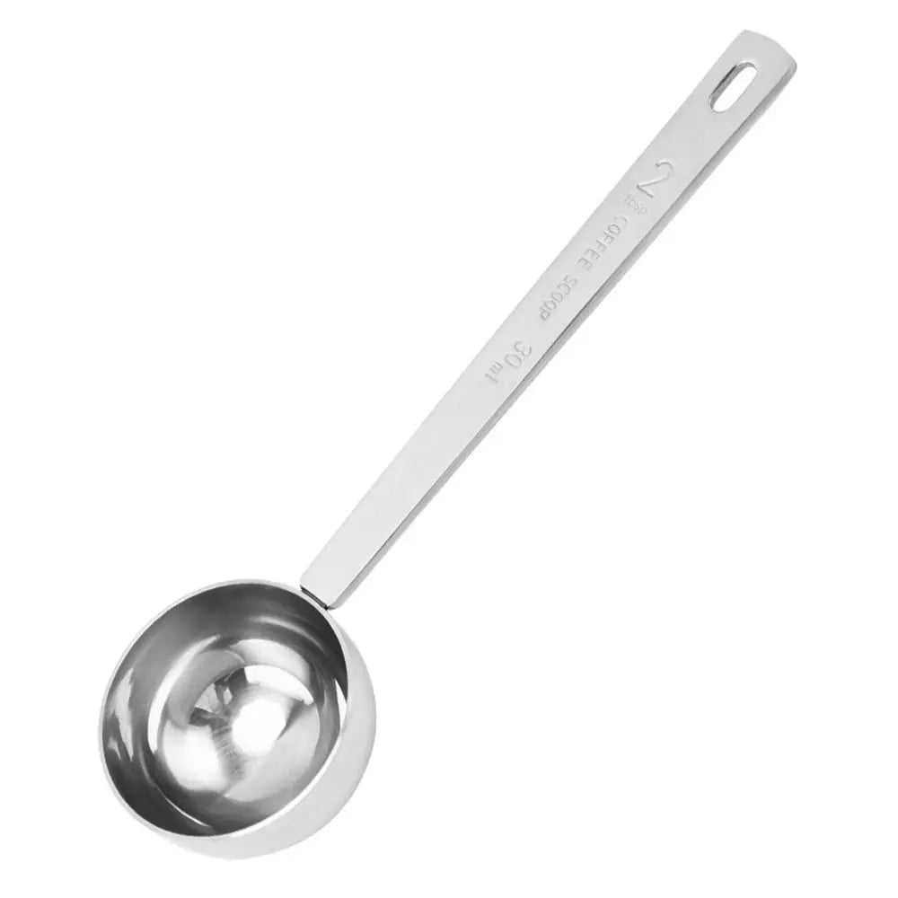 Metal measuring spoon on a white background