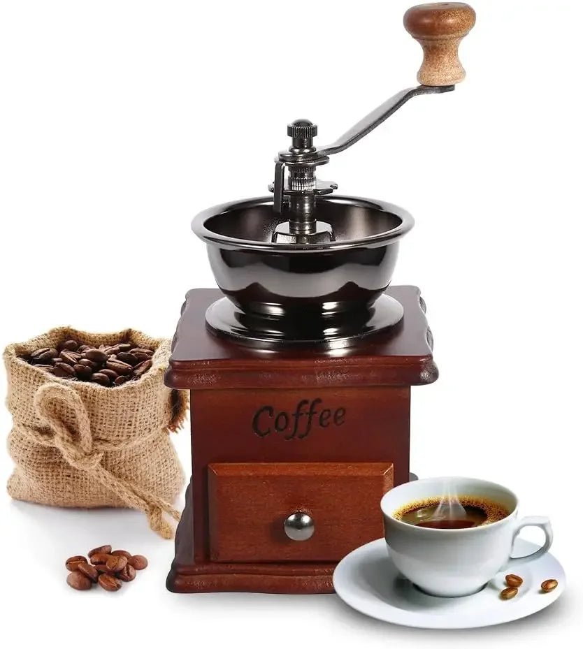 Wooden coffee grinder with a cup of coffee and coffee beans on a white background