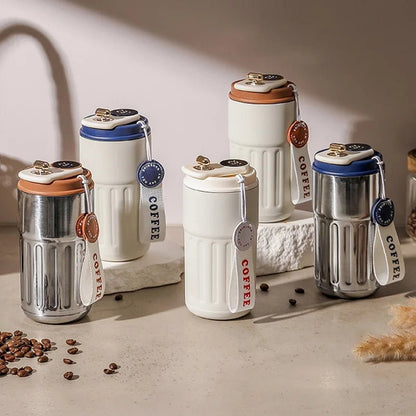 Set of white coffee tumblers with colorful lids on a light surface with coffee beans.